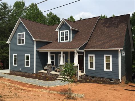 blue house with brown metal roof|siding colors for brown roof.